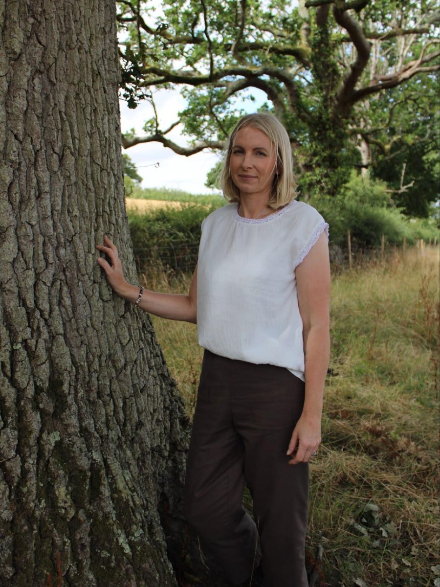 Anna Scattergood, counsellor, standing beside an oak tree